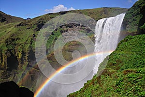 Icelandic waterfall Skogafoss, part of it with a rainbow