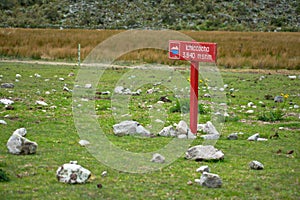 Ichiccocha sign in a green meadow in Huascaran National Park