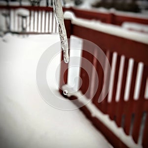 Icicle dripping water on porch