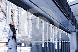 Icicle is hanging from a roof