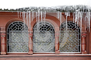 Icicle at a wooden house with lead glazing windows