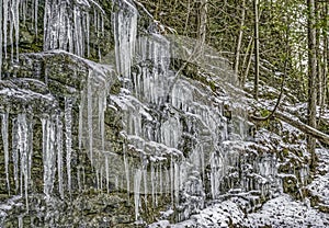 Icicles on a rock cliff face in late Fall