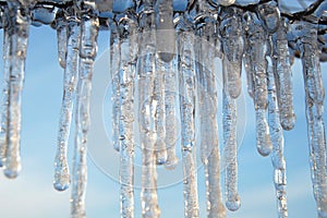 Icicles on the background of the blue sky