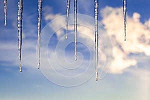 Icicles on the background of a blue sky.