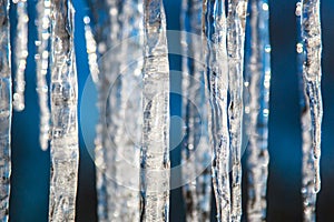 Icicles on a bright spring sun close, blurred abstract background