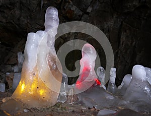 Icicles in a cave illuminated in color