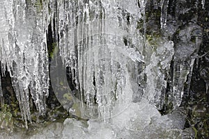 Icicles Formation on Side Of Mountain Rocks