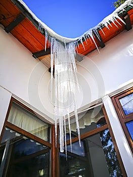 Icicles formed on an eaves of a house in winter