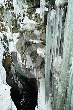 Icicles in gorge landscape steep rock face