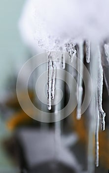 Icicles hang from the old roof in the spring thaw