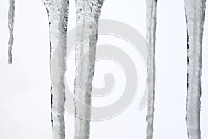 Icicles hanging on the roof. Winter nature abstract art.