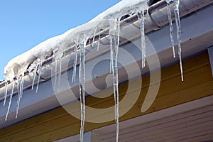 Icicles on house eaves photo