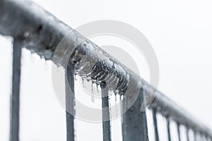 Icicles melting on a fence