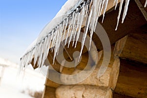 Icicles on an old log-house