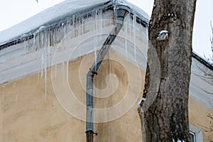 icicles on the roof of an old house