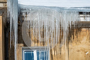 icicles on the roof of an old house