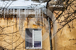 icicles on the roof of an old house