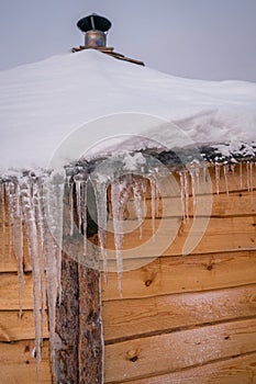 Icicles on the roof of wooden Hut