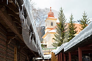 Icicles and snow on an old wooden cottage