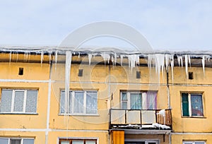 Icicles and snow on the roof of the house