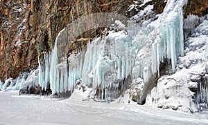 Icicles of splashed ice on steep rock
