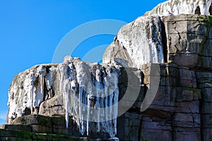 Icicles on top of a mountain photo