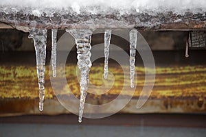 Icicles on vintage roof closeup. Winter weather concept. Froze and ice background. Snow and icicle. Melting icicles.