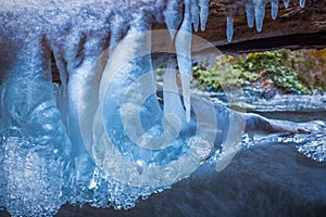 Icicles and water flow of the river