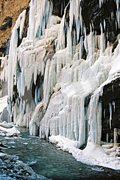 Icicles waterfall on the edge of the river