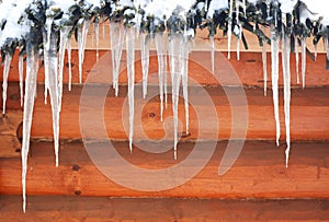 Icicles on a wooden background