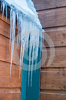 Icicles on a wooden structure in winter after snowstorm