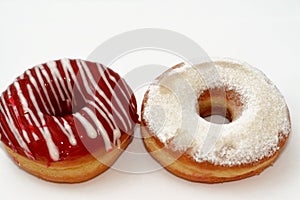 Icing powdered confectioners' sugar and Strawberry flavored ring donut, A glazed, yeast raised, American style ring doughnut