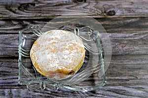 Icing powdered sugar donut filled with strawberry sauce, a doughnut or donut, a type of food made from leavened fried dough,