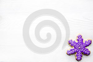 Icing snowflake gingerbread cookie on white background, Christmas baking. Copy space