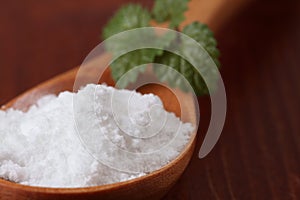 Icing sugar in a wooden spoon