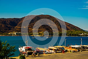 ICMELER, TURKEY: Landscape with a view of the coast and ships in Icmeler on a sunny summer day, near Marmaris in Turkey.