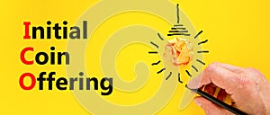 ICO initial coin offering symbol. Concept words ICO initial coin offering on beautiful paper. Beautiful yellow background.