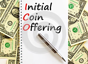 ICO initial coin offering symbol. Concept words ICO initial coin offering on beautiful white note. Beautiful dollar bills