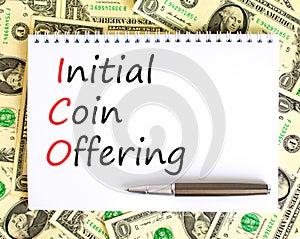 ICO initial coin offering symbol. Concept words ICO initial coin offering on beautiful white note. Beautiful dollar bills