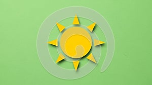 Icon with a central circle and eight triangular rays on a light green