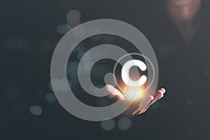 Icon in the hand of a businessman, concept of copyright or intellectual property patent protection of copyright infringement
