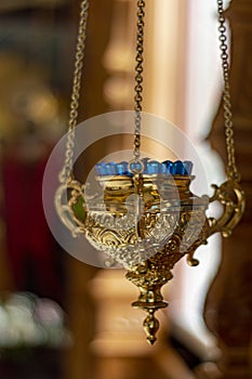 Icon lamp in front of icon in Orthodox Church. Indoors, day light Front view photo