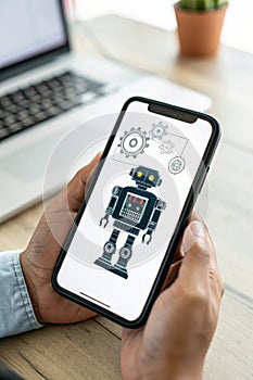 Robot icon on mobile screen representing AI deep learning photo