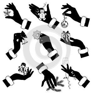 Icon set of black silhouettes of female hands holding Christmas and New Year decorations and symbols