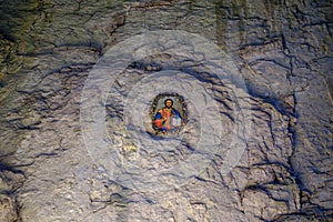 Icon on the stone wall inside cave 1