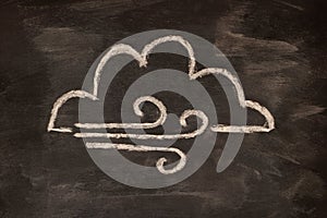 Icon for weather forecast, cloudy, windy, chalk drawn on blackboard.