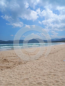 Iconic Banyuwangi (indonesia) Beach called Pantai Pulau Merah with blue sky and a uninhabited island. taken at May, 2023