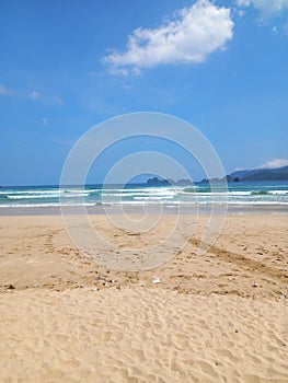 Iconic Banyuwangi (indonesia) Beach called Pantai Pulau Merah with blue sky and a uninhabited island. taken at May, 2023