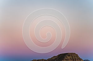 Iconic bardenas desert mountain at sunset with pink sky