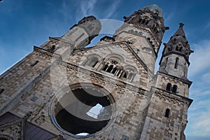 Iconic Berlin GedÃÂ¤chtniskirche Low Angle - Dramatic low-angle view emphasizes the massive scale and war damage of the historic